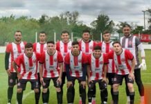 Rivadavia de Río Primero perdió en Devoto en su debut en el Torneo Competencia Jugadores de Rivadavia de Río Primero posan con su camiseta en una cancha de fútbol
